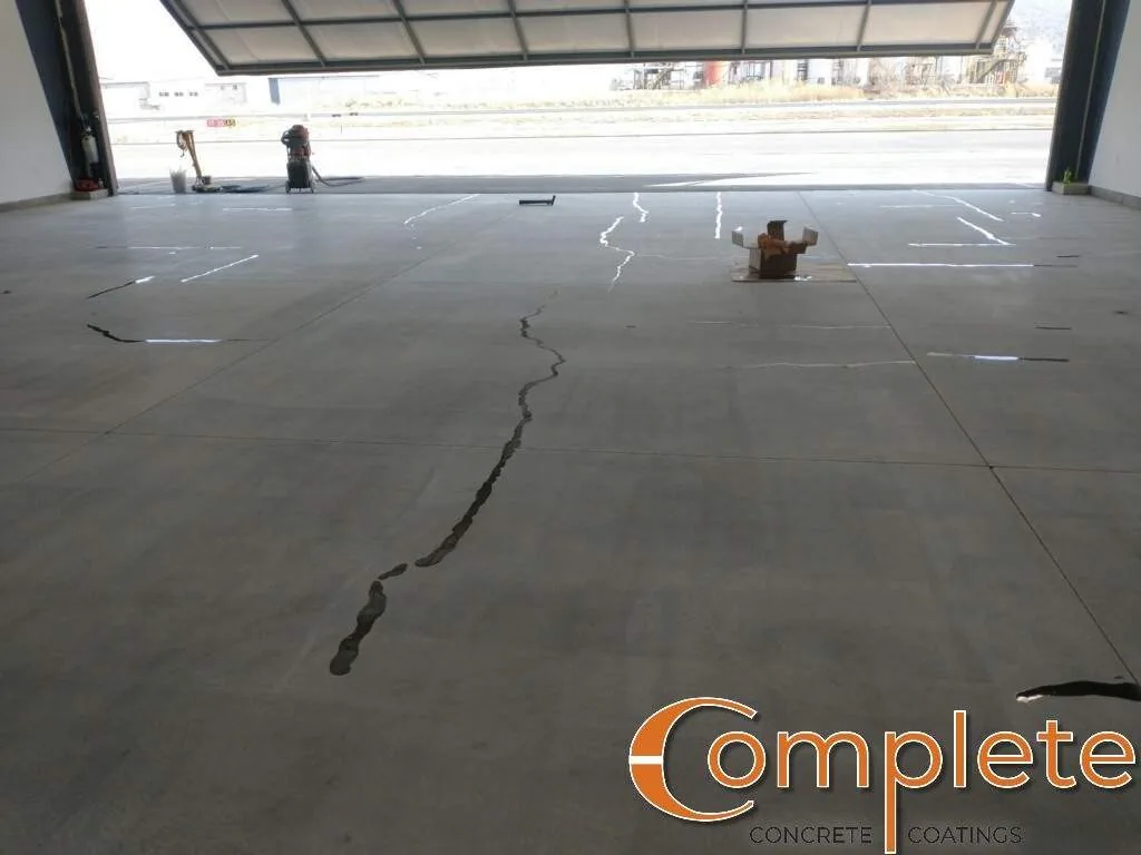 Cracked concrete slab with the cracks marked for repair
